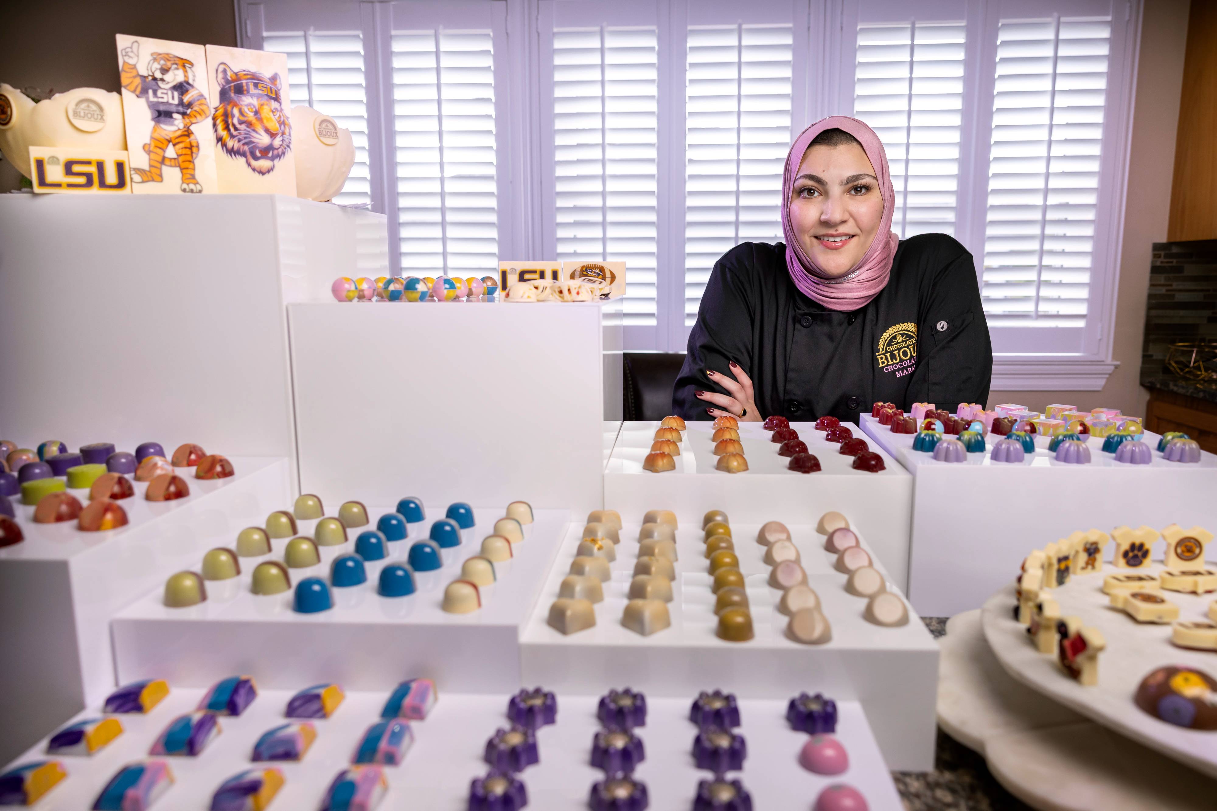 LSU grad Maram Khalaf stands with her chocolate